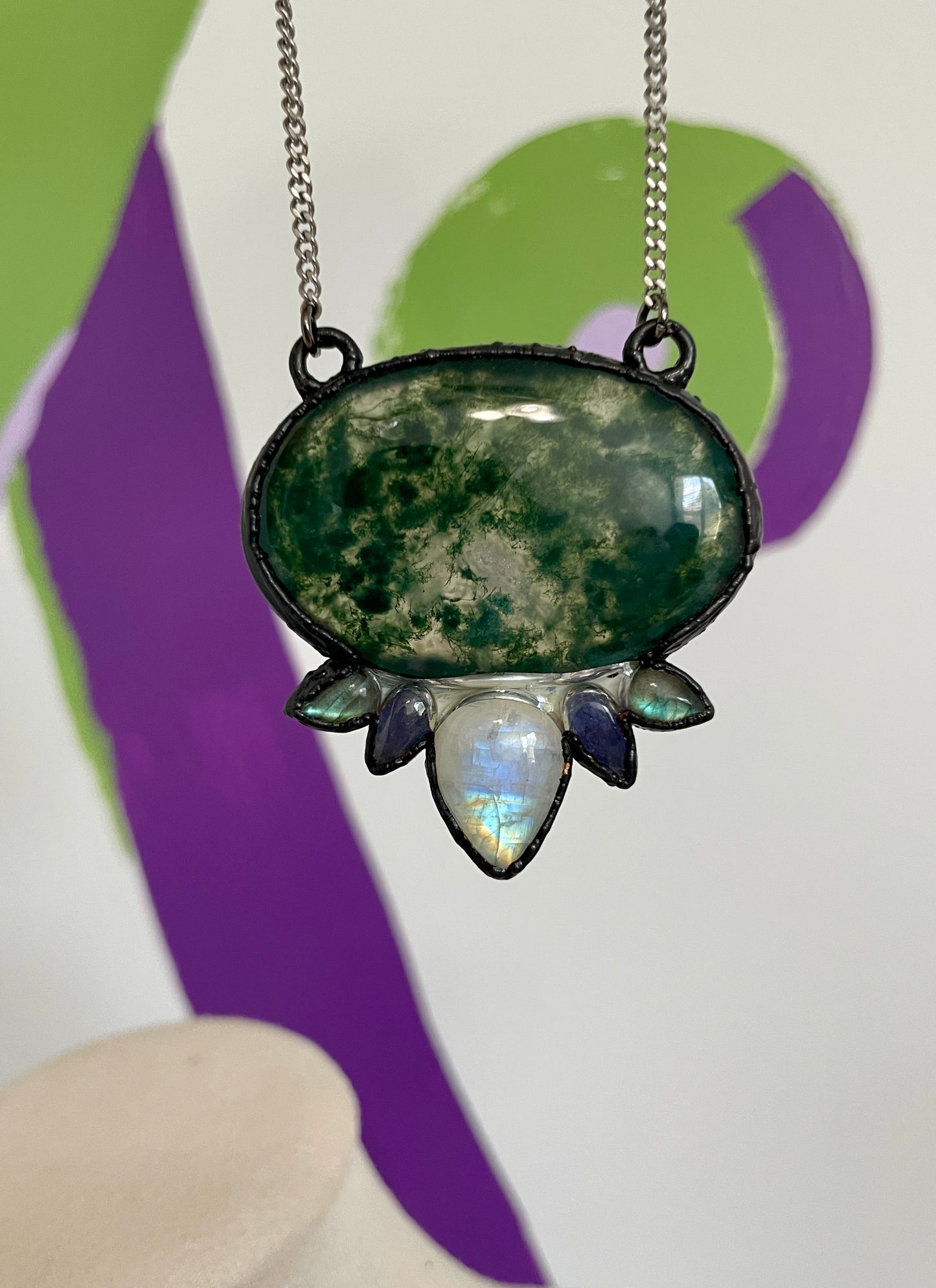 Moss agate statement necklace electroformed in gunmetal with moonstone and labradorite crystal petals, suspended from a stainless steel flat Cuban chain.